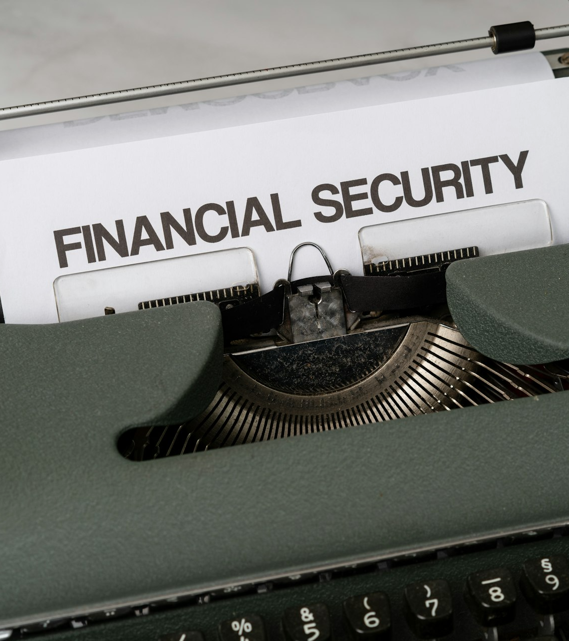 a close up of a typewriter with a financial security sign on it