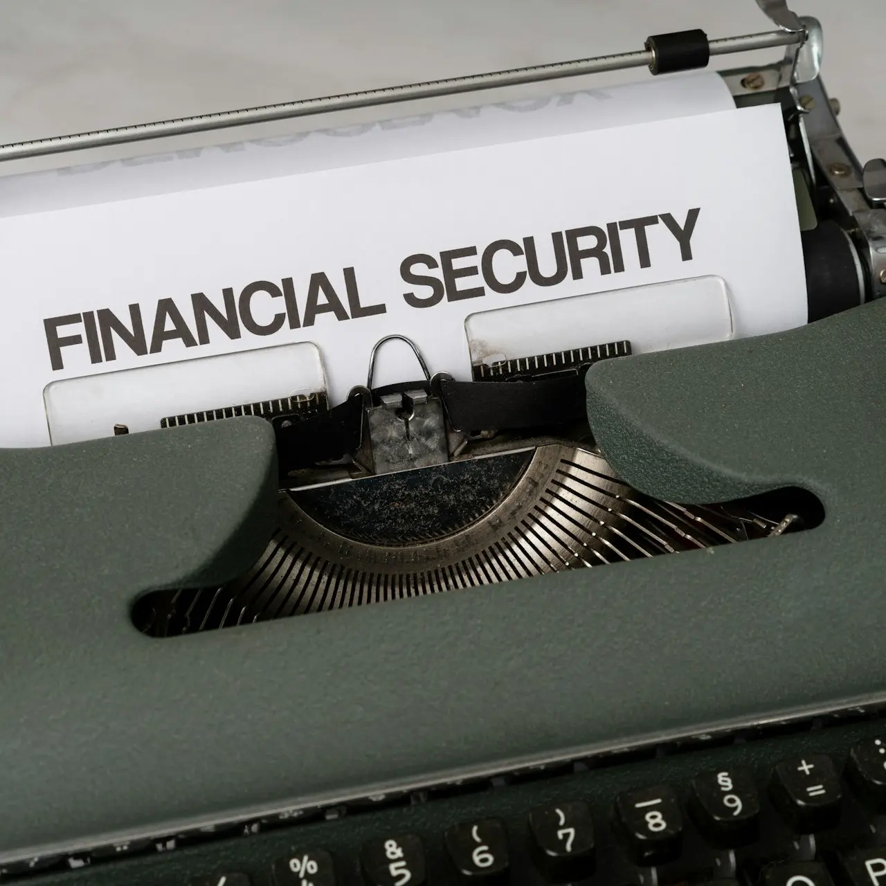 a close up of a typewriter with a financial security sign on it