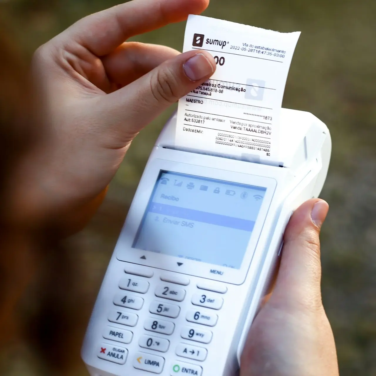 a person holding a cell phone and a receipt